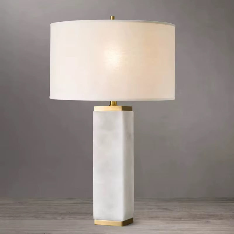 White quartz Serra table lamp against a pale grey background showing the stone column