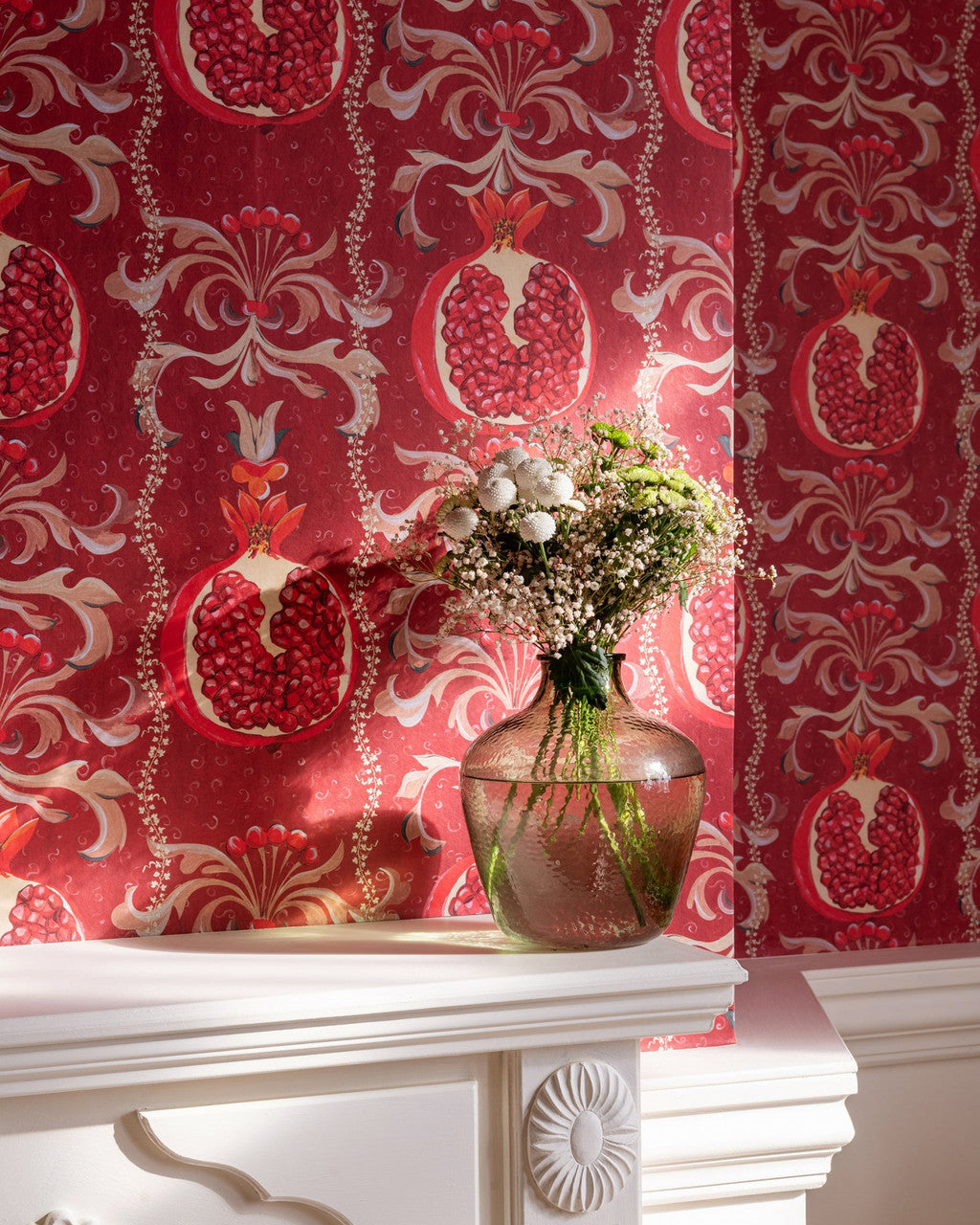 Melagranata wallpaper in Red by Natty & Polly, styled in a living room