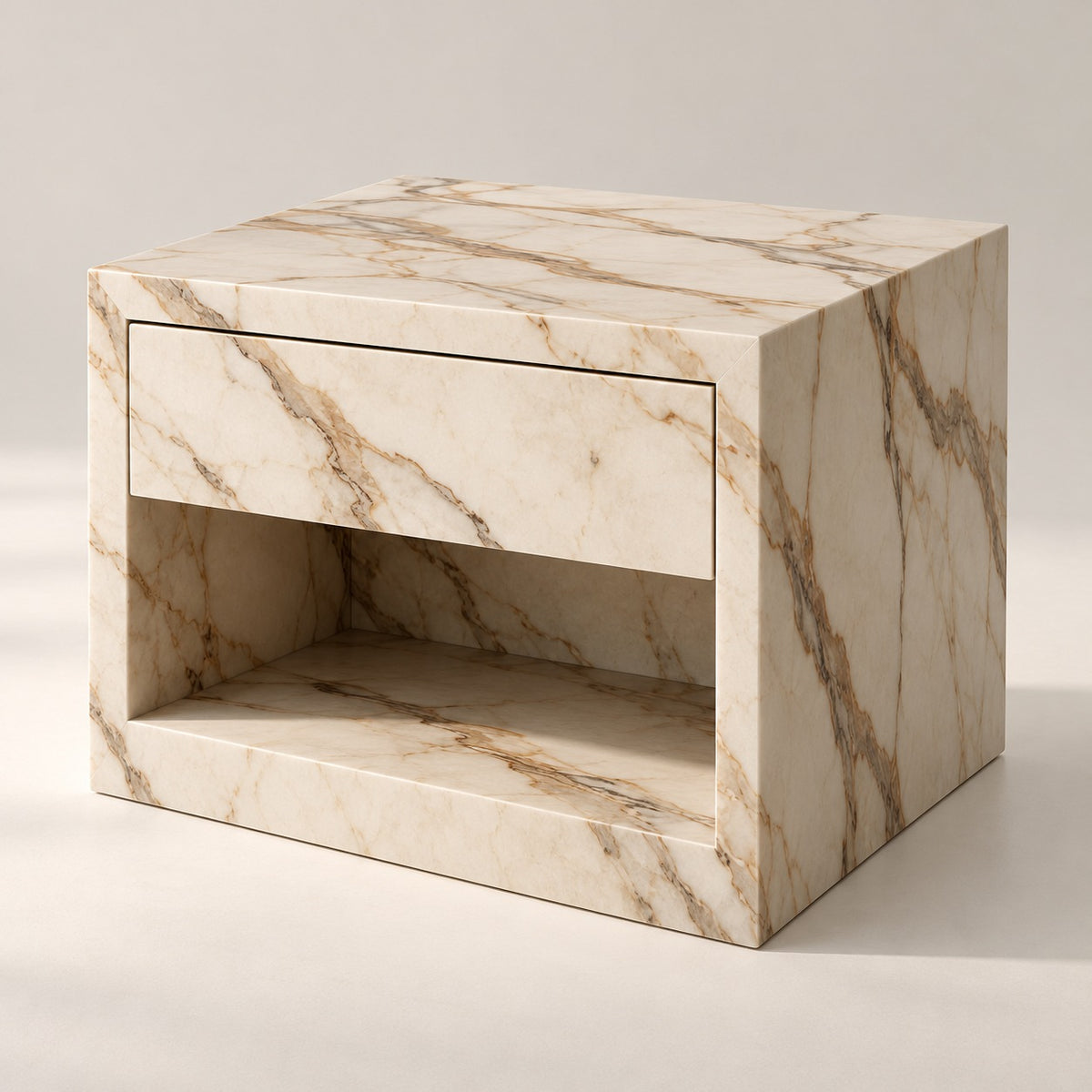Evalina Calacatta marble bedside table, three-quarter view showing drawer and open shelf
