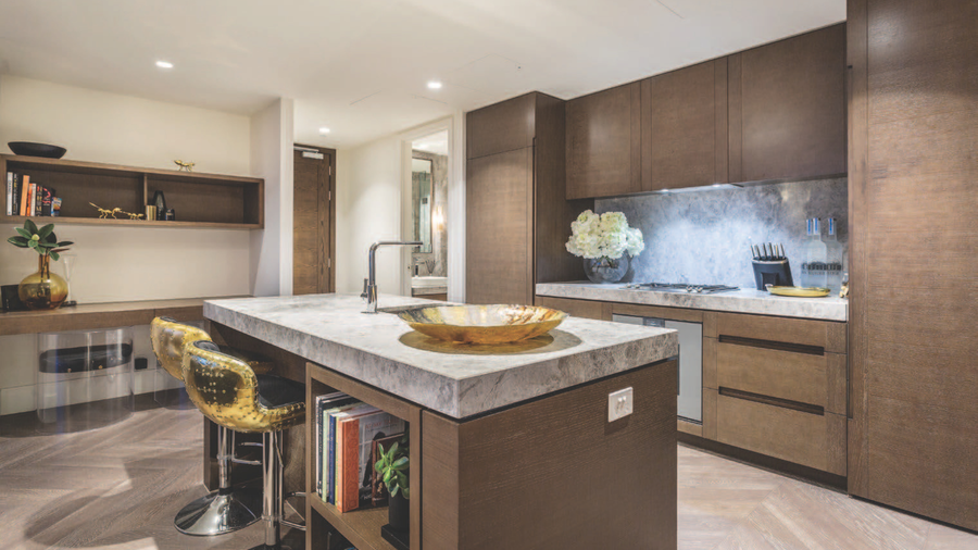Marble kitchen island with gold bar stools
