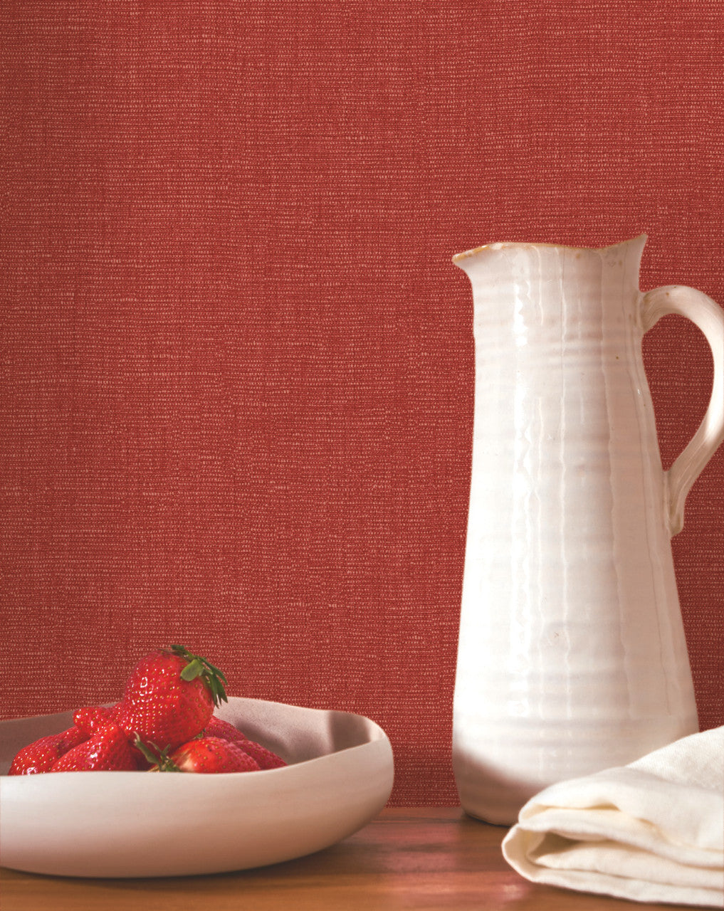 Caractère wallpaper in Lipstick Red by Natty & Polly, styled in a living room