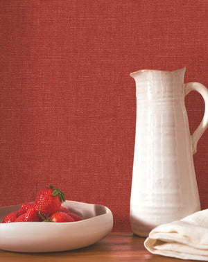 Caractère wallpaper in Lipstick Red by Natty & Polly, styled in a living room