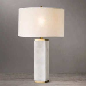 White quartz Serra table lamp against a pale grey background showing the stone column