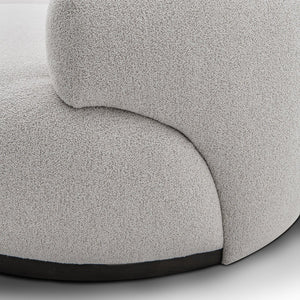Maison Debrah Lunève curved three-section sofa in warm oatmeal fabric on a dark grey plinth — view 4