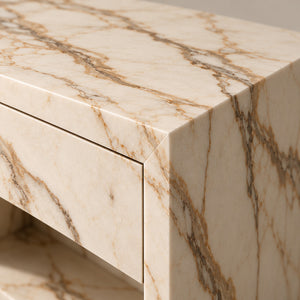 Close-up of Calacatta marble veining wrapping the edge of the Evalina bedside table